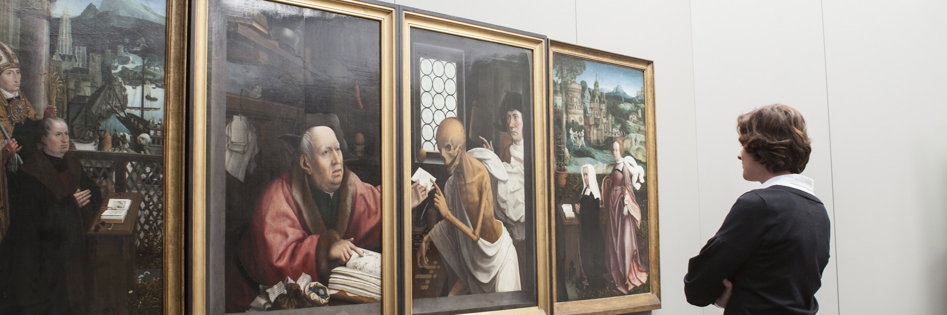 Woman viewing paintings (Hugo Van der Goes - St Hippolyte's Triptich) at Groeningemuseum.