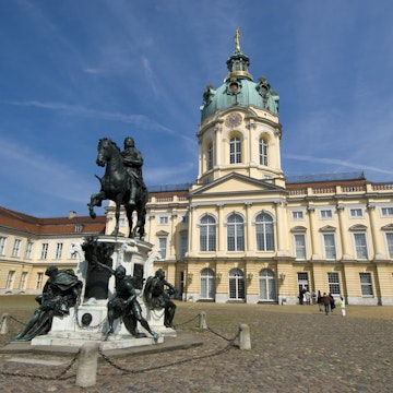 Statue of the Great Elector Frederick William of Brandenburg standing in grand courtyard of Charlottenburg Palace.