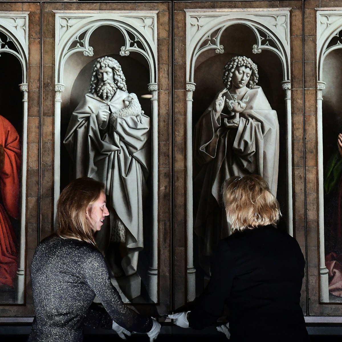 Officials unveil the restored exterior panels of "The Adoration of the Mystic Lamb", an altar piece painted by the Van Eyck brothers in 1432, at Saint Bavo Cathedral in Ghent on October 12, 2016. .The restoration of the exterior panels and frames started in 2012, and constitutes the first phase of restauration which will be followed by two other phases for the interior panels and is set to last until 2020. / AFP / EMMANUEL DUNAND        (Photo credit should read EMMANUEL DUNAND/AFP/Getty Images)