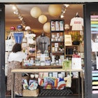 An employee adjusts face masks displayed for sale in an open window for curbside pickup at a Lockwood store in the Astoria neighborhood in the Queens borough of New York, U.S., on Friday, June 5, 2020. For New York's small businesses, which depend almost entirely on city residents, Monday marked a vital moment to start bringing in the customers and revenue they lost during the shutdown  an undertaking all the more precarious with the current social unrest. Photographer: Gabby Jones/Bloomberg via Getty Images