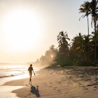 A woman walking at sunrise on the Caribbean Coast of Colombia