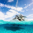 C:\DCIM\100GOPRO\GOPR8255.GPR
1453215525
Picture parted in half above and half underwater image of Lagoon Catamaran anchored in Musha Cay, Exuma, Bahamas