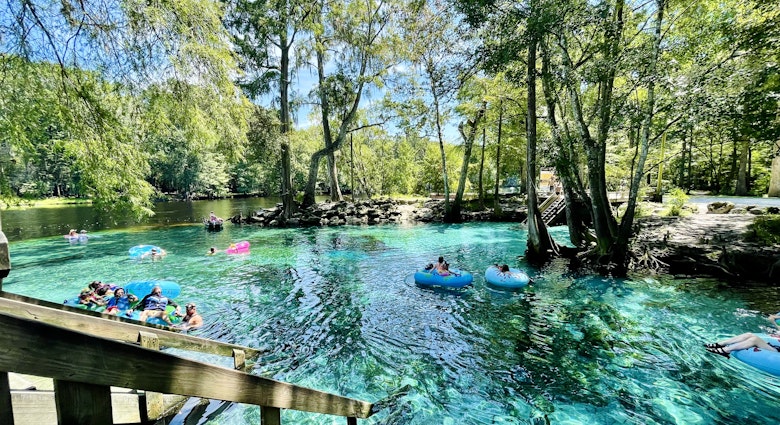 Tubers and swimmers float in the shallow clear aqua spring waters near Devil's Eye in the Devil's Run spring, Ginnie Springs, Florida
1498981596