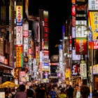 A Tokyo street at night lined with neon lights