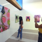 MIAMI, FLORIDA - DECEMBER 10: Guests admire an acrylic on canvas painting titled Affluence by Akila Watts of the Bahamas presented by Filo Sofi Arts Gallery at the 11th annual PRIZM Art Fair as part of Art Basel Miami Beach on December 10, 2023 in Miami, Florida. (Photo by Sean Drakes/Getty Images)
1855617110
akilah watts, prizm