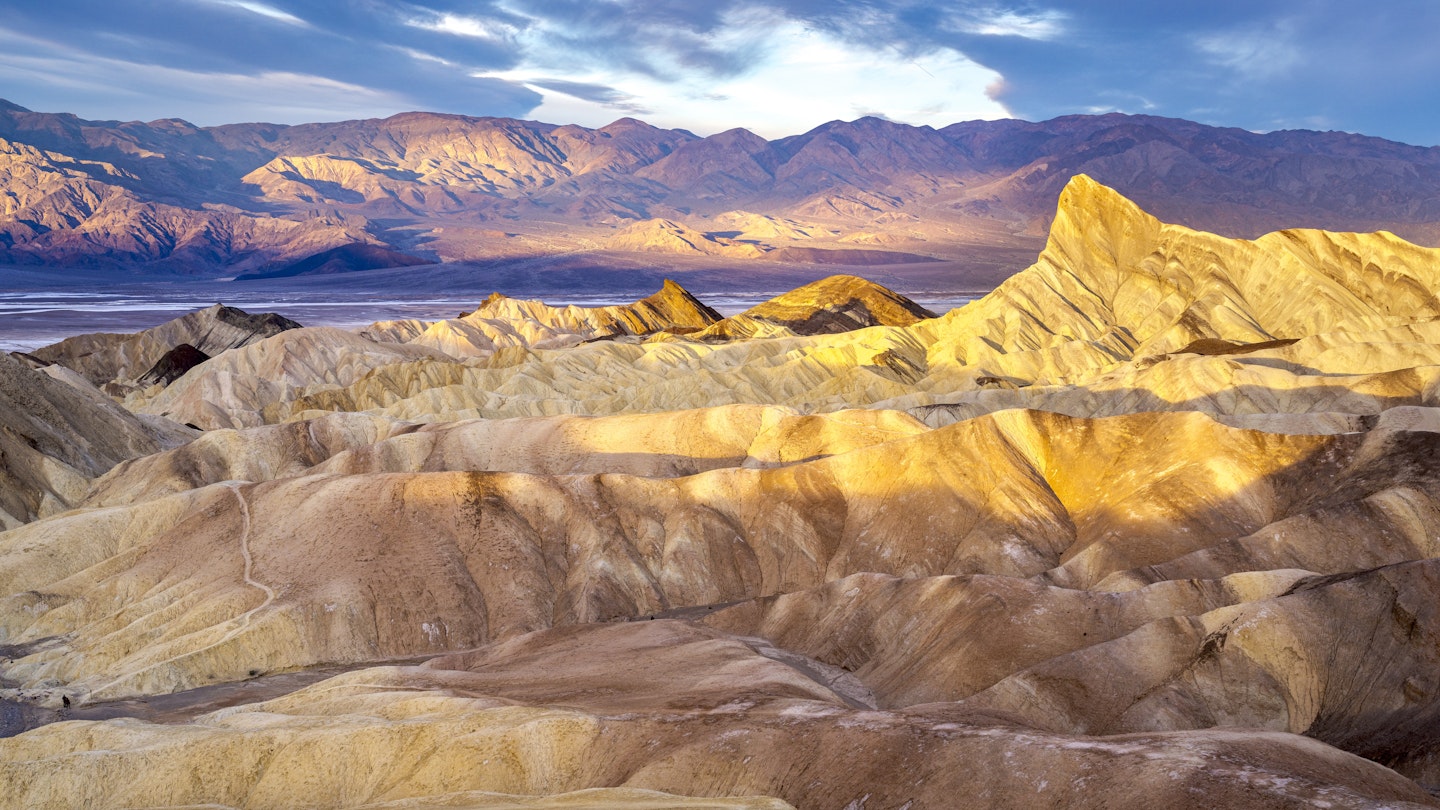 2148616692
Hikers on the slopes of Zabriskie Point at sunrise in Death Valley National Park in California, United States - stock photo
Hikers on the slopes of Zabriskie Point at sunrise in Death Valley National Park in California, United States