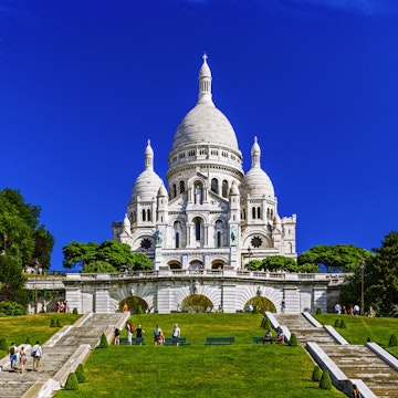 Built Structure City Architecture Travel Destinations Horizontal Outdoors Dome France Church Blue International Landmark French Culture Tree Day Paris - France Montmartre Religion Christianity Steps Color Image Grass Basilica City Life Incidental People Building Exterior Photography Distant Capital Cities Clear Sky Basilique Du Sacre Coeur - Montmartre WIllette Goutte D'Or Sunny
Sacre-Coeur Basilica on the mound Montmartre, Willette Public Garden, Montmartre District, Paris, France