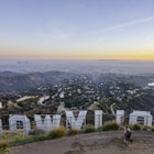 Los Angeles, United States - February 04, 2018: A couple point at famous Hollywood sign just before sunset. Photograph taken from Mt Lee peak. Hollywood sign was built in 1923 and the most iconic place in Los Angeles  California.
985869474