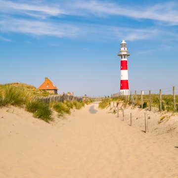 Lighthouse on the coast of the North Sea in a sunny day, Belgium