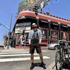 Writer James March stands in front of a bike during a sunny day in front of of Whiskey a Go Go on the Sunset Strip