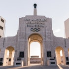 The exterior showing Olympic rings of the Los Angeles Memorial Coliseum, which will host the opening ceremonies and track-and-field events for the 2028 Olympic Games.