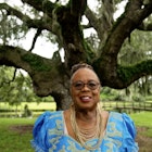 Kitty Green, Gullah Geechie Tour leader, St. Helena, Island, SC..2025 BIT Best In Travel .South Carolina's Low Country and Coastal Georgia
Kitty Green, Gullah Geechie Tour leader, St. Helena, Island, SC
Accessories,  Adult,  Blouse,  Face,  Female,  Glasses,  Grass,  Grove,  Happy,  Head,  Land,  Nature,  Oak,  Outdoors,  Park,  Person,  Photography,  Portrait,  Smile,  Tree,  Tree Trunk,  Vegetation,  Woman,  Woodland
Kitty Green, Gullah Geechie Tour leader, St. Helena, Island, SC

2025 BIT Best In Travel