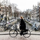 Amsterdam Cyclist traveling over a bridge.; Shutterstock ID 596120624; GL: 65050; netsuite: Lonely Planet Online Editorial; full: Best things in Amsterdam; name: Brian Healy
596120624
amsterdam, bicycle, bike, biking, blue, bridge, canal, city, culture, cycle, cyclist, dutch, europe, holland, man, netherlands, people, person, rain, ride, sky, tourism, traffic, transportation, travel, urban, women