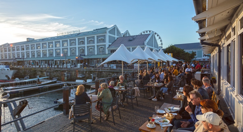 People Enjoying Beautiful Sunset in Restaurant.   Waterfront -Cape Town ,South Africa 11-11-2017, License Type: media, Download Time: 2024-08-30T14:45:46.000Z, User: bfreeman_lonelyplanet, Editorial: true, purchase_order: 65050, job: Online Editorial, client: Things to know South Africa, other: Bailey Freeman