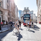 London, UK - June 26, 2018: Many people men pedestrians on bicycles riding waiting for traffic light on bikes street road in center of downtown financial district city, old architecture, sunny summer; Shutterstock ID 1128728999; your: Brian Healy; gl: 65050; netsuite: Lonely Planet Online Editorial; full: Cycling in London
1128728999