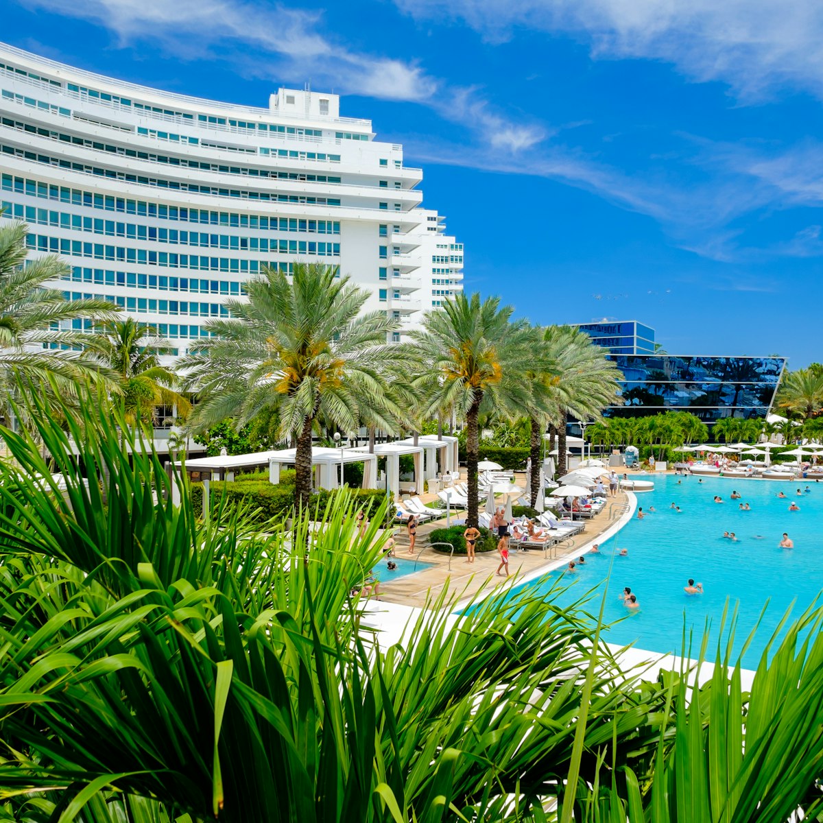 MIAMI BEACH, FLORIDA USA  - APRIL 21, 2013: The historic Fontainebleau Hotel by architect Morris Lapidus on Miami Beach is a popular international tourist destination.
188451383
outdoor, sunlight, tree, destination, usa, tropical, travel, attraction, south, avenue, resorts, deco, sunny, swimming, united, building, miami, tourist, lifestyle, states, beach, collins, architecture, blue, drive, colorful, pool, beauty, sky, scenic, hotels, tourism, art, beautiful, palm, pretty, florida, vacation, ocean, cityscape, morris lapidus, fontainebleau hotel, fontainebleau, sobe