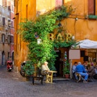 Cozy old street with a bar in Trastevere, on the west bank of the Tiber in Rome.
676279021
ambience, building, cafe, chairs, city, comfortable, cozy, dinner, europe, european, food, green, house, italia, italian, italy, lamp, lazio, old, outdoor, plant, restaurant, roma, roman, rome, rome cafe, rome cityscape, rome italy, rome restaurant, rome street, small, street, table, terrace, trastevere, tree, wall