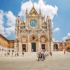 July 9, 2015: Exterior of Duomo di Siena, a medieval church in Siena.
695817532
ancient, architecture, attraction, basilica, blue, building, cathedral, church, city, duomo, europe, famous, heritage, historic, history, italy, landmark, medieval, old, religion, renaissance, siena, square, tower, town, tuscany