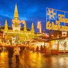 Traditional Christmas market in Vienna lit up at night.