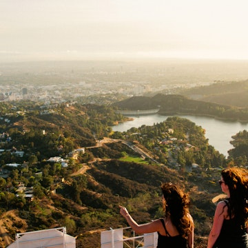 Two woman looking out over the Los Angeles skyline.