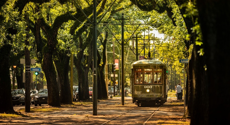 New Orleans, Louisiana - June 18, 2019: Passengers ride the historic railway streetcar along Saint Charles Avenue in the Garden District of New Orleans Louisiana USA.