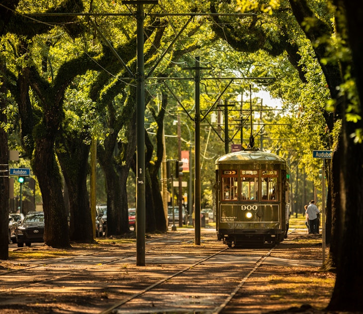 New Orleans, Louisiana - June 18, 2019: Passengers ride the historic railway streetcar along Saint Charles Avenue in the Garden District of New Orleans Louisiana USA.