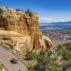 A car climbs a ridge in Colorado National Monument.